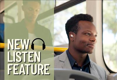 Man listening to audio via AirPods on a public transit bus. He looks happy.